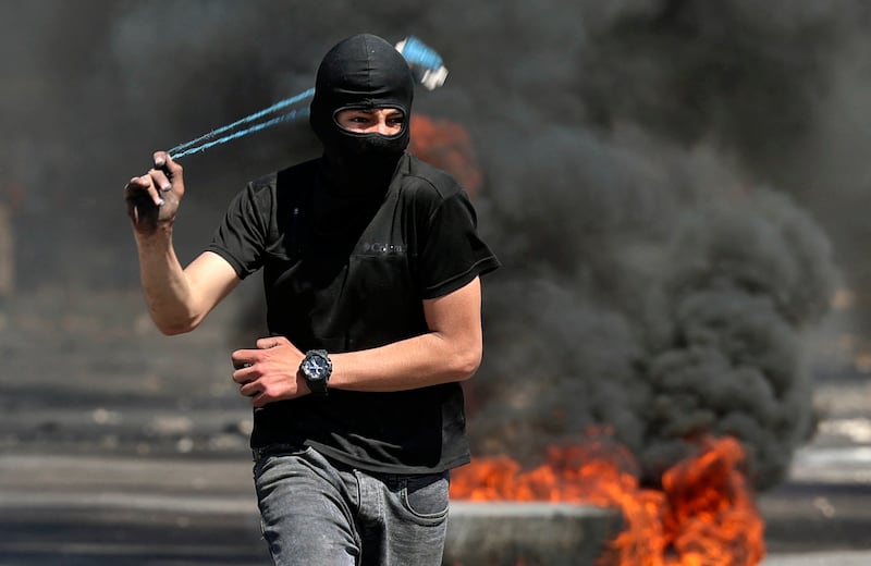 A Palestinian protester uses a sling during a confrontation with Israeli security forces during a demonstration against Jewish settlements, at Beita, in the occupied West Bank. AFP