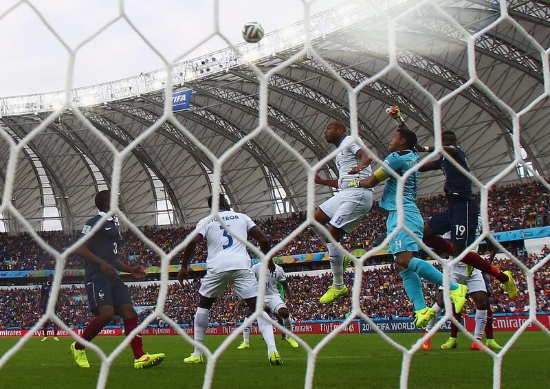 Jerry Bengtson and goalkeeper Noel Valladares of Honduras jump with Paul Pogba of France during their match at the 2014 World Cup on Sunday in Porto Alegre, Brazil. Jeff Gross / Getty Images