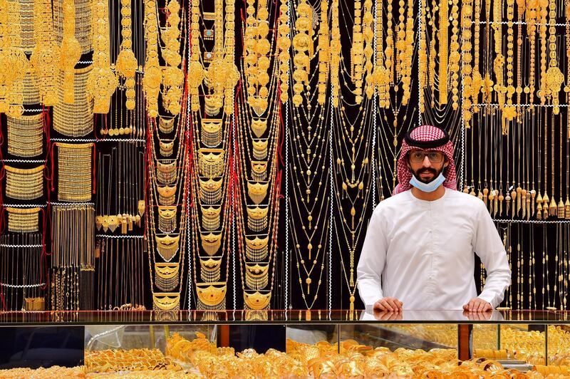 A merchant displays gold jewellery at his shop in Dubai Gold Souk in the Gulf emirate on July 29, 2020. (Photo by GIUSEPPE CACACE / AFP)