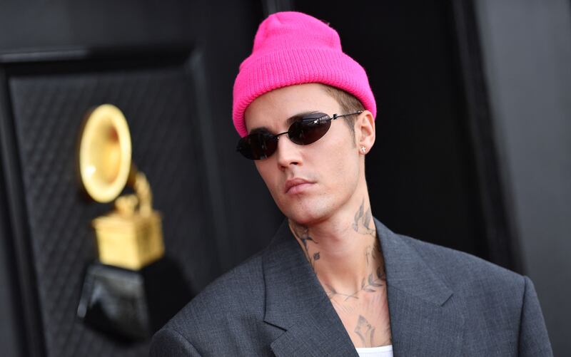 Justin Bieber wore an oversized grey suit by Balenciaga, accessorised with a hot pink beanie. AFP