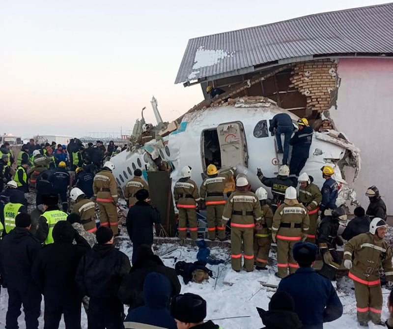 In this handout photo provided by the Emergency Situations Ministry of the Republic of Kazakhstan, police and rescuers work on the site of a plane crash near Almaty International Airport, outside Almaty, Kazakhstan. AP