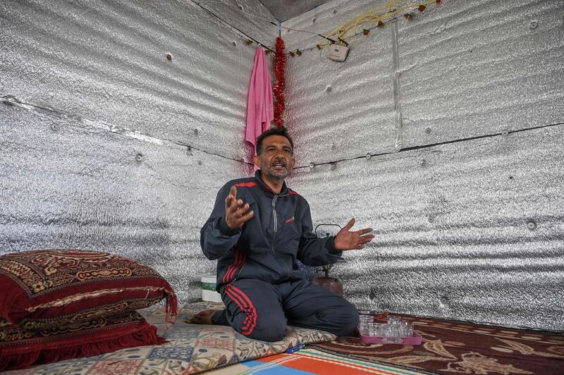 Hamad al-Abdallah, speaks to AFP in his new concrete home at a camp created by Turkey's Humanitarian Relief Foundation (IHH) near Kafr Lusin on the border with Turkey in Syria's northwestern province of Idlib, on March 10, 2020. Abdallah fled with his wife and four children when the forces of Syrian President Bashar al-Assad, backed by Russia and Iran, began their assault on the last rebel hold-out of Idlib. / AFP / Ozan KOSE
