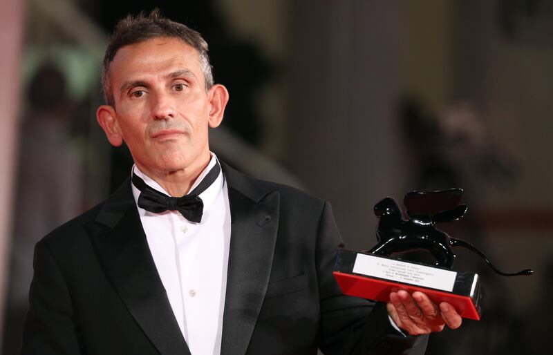 Director Michelangelo Frammartino poses with the Special Jury Prize for 'Il Buco' (The Hole). Getty Images