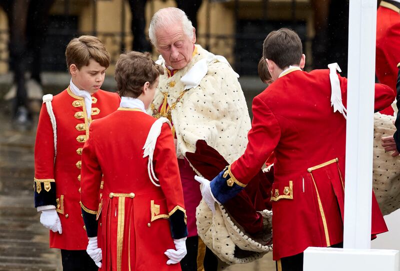 Prince George, left, serves as a page to King Charles III at Westminster Abbey. AP
