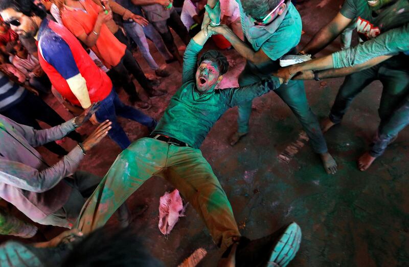 Men daubed in colours take part in "Lathmar Holi" celebrations inside a temple in the town of Barsana, in the northern state of Uttar Pradesh, India, March 4, 2020. Reuters