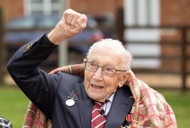 (FILES) In this file handout photo released  on April 30, 2020, shows Captain Tom Moore shows Captain Tom Moore waving at a flypast by Battle of Britain Memorial planes to celebrate his 100th birthday in Marston Moretaine. Britain's lockdown hero, Captain Tom Moore has died at the age of 100 after testing positive for Covid-19.  The charity fundraiser was taken to Bedford Hospital on Sunday after testing positive for coronavirus last week. - RESTRICTED TO EDITORIAL USE - MANDATORY CREDIT "AFP PHOTO / CAPTURE THE LIGHT / EMMA SOHL" - NO MARKETING NO ADVERTISING CAMPAIGNS - DISTRIBUTED AS A SERVICE TO CLIENTS --- NO ARCHIVE ---

 / AFP / CAPTURE THE LIGHT / Emma SOHL / RESTRICTED TO EDITORIAL USE - MANDATORY CREDIT "AFP PHOTO / CAPTURE THE LIGHT / EMMA SOHL" - NO MARKETING NO ADVERTISING CAMPAIGNS - DISTRIBUTED AS A SERVICE TO CLIENTS --- NO ARCHIVE ---

