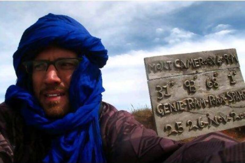 The writer braves cold winds on the summit of Mt Cameroon, which rises 4,090 metres above sea level. Scott MacMillan for The National