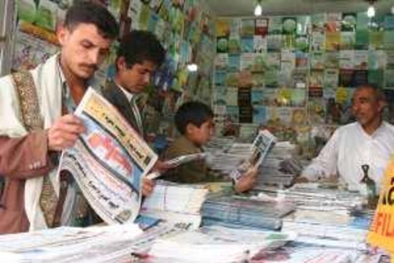  Young Yemenis read newspapers at a newsagent shop at Hael street in the capital Sana'a, Sunday, Feb. 15, 2009. Mohammed al Qadhi/The National  *** Local Caption ***  info -1.JPG