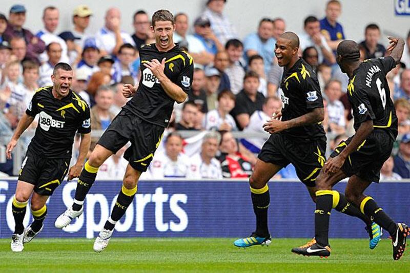 Gary Cahill, centre left, celebrates scoring in Bolton's 4-0 demolition of Premier League new boys QPR. Bolton are top of the league after one game.

Dylan Martinez / Reuters