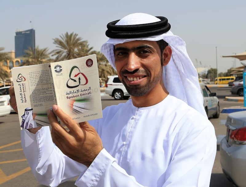 Abdulla Al Kaabi, one of the authors showing his first edition of the “Emirati Ramsa” dictionary which provides the translation of about 1,500 Emirati words into English. Ravindranath K / The National 