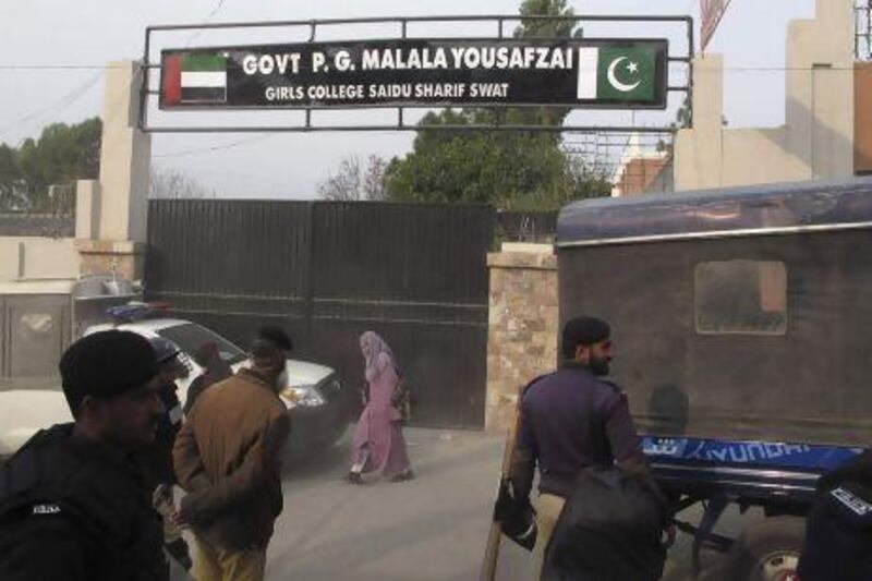 Police officers stand guard after students protest against the naming of Saidu Sharif College after schoolgirl Malala Yousufzai, in the Swat Valley.