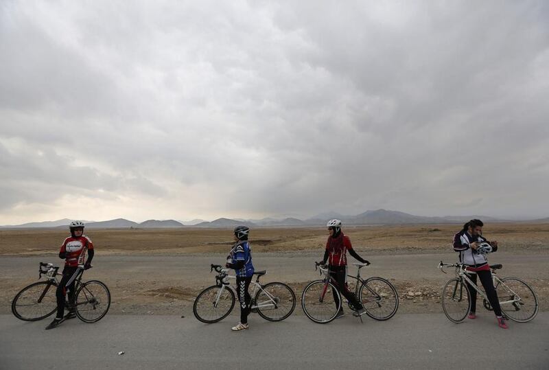 Malika Yousufi, right, Masooma Alizada, second right, Frozan Rasooli, third right, and Zahra Alizada, left, members of Afghanistan’s Women’s National Cycling Team take a break from training. Mohammad Ismail / Reuters