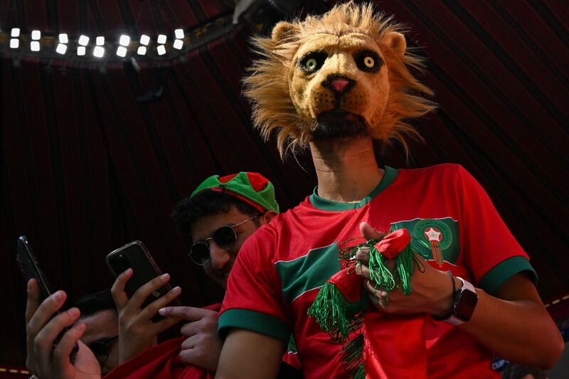 A Morocco supporter wearing a lion mask for the game against Croatia. The Moroccan team's nickname is The Atlas Lions. AFP