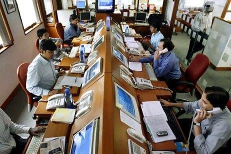 Stockbrokers trade in Mumbai. Many Indian-born executives are returning home, trading their dream of conquering Wall Street or Silicon Valley for working in Gurgaon or Mumbai. Reuters