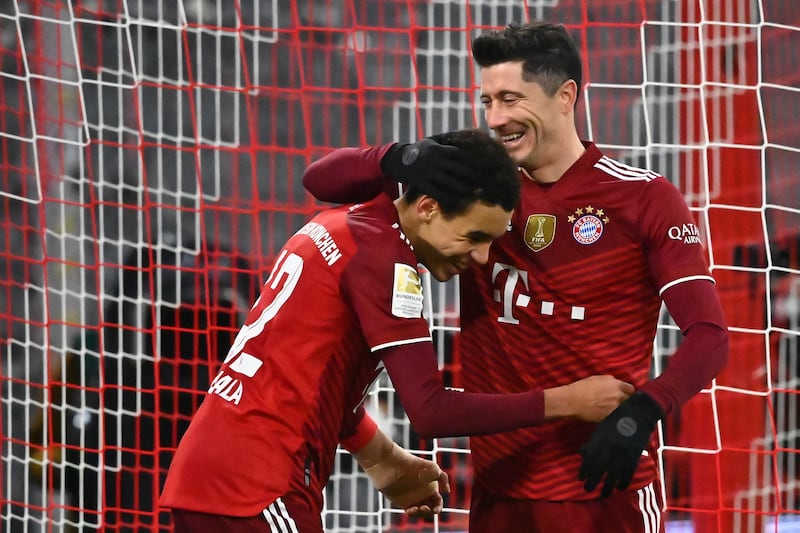 Lewandowski celebrates with teammate Jamal Musiala. EPA