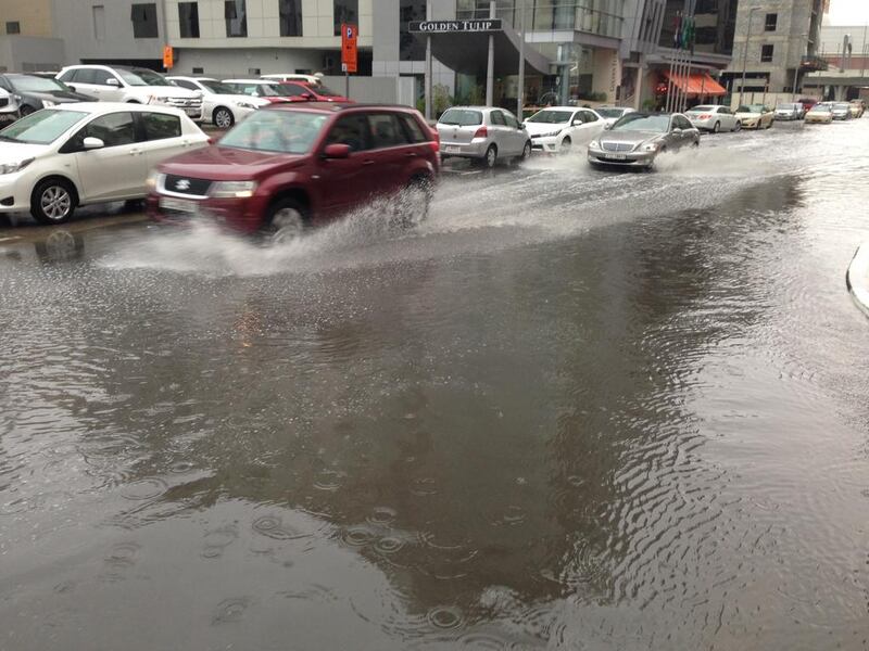 Cars drive through standing water in Barsha, Dubai. Antonie Robertson / The National