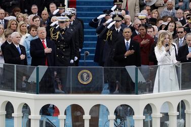 US President Donald Trump and Vice President Mike Pence, far left, at Mr Trump's inauguration ceremony in 2017, an event that was attended by former president Barack Obama and his wife Michelle. AP 