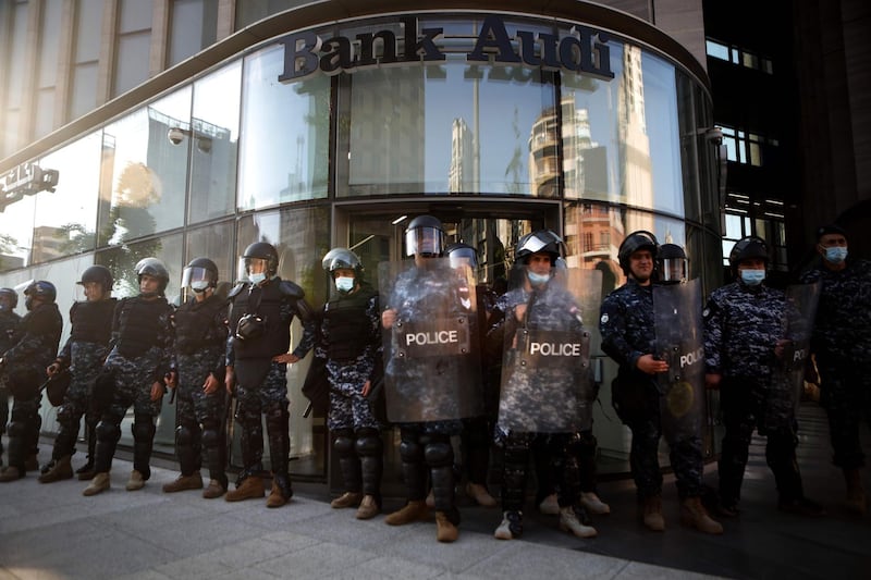 Lebanese riot police guard a bank in the capital Beirut.  AFP