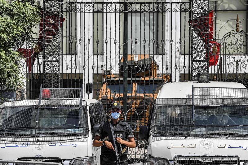 A member of Tunisia's security forces stands guard outside parliament headquarters in Bardo in Tunis on July 31, 2021.  AFP