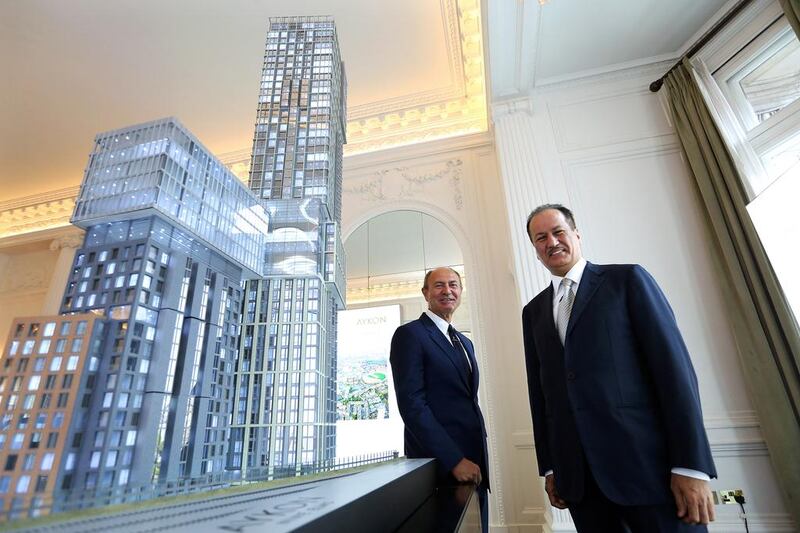 Gian Giacomo Ferraris, CEO of Versace, and Hussein Sajwani, chairman of Damac (right) with a model of the Aykon Nine Elms fashion branded residence at the launch in London.  Stephen Lock for the National