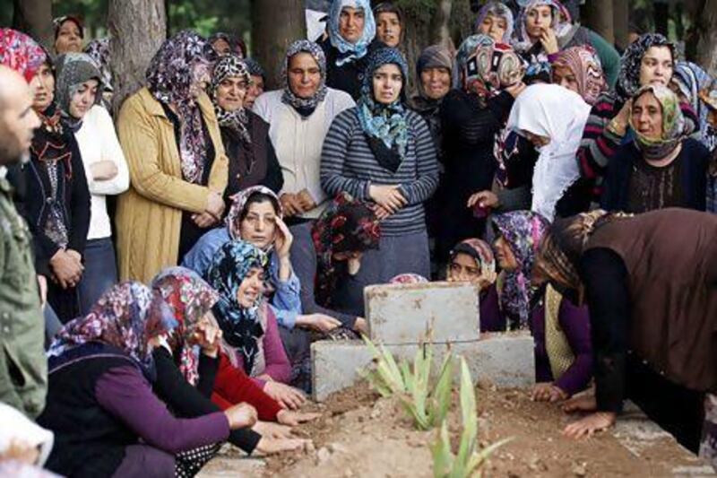 Relatives of Ahmet Uyan, 45, and Ahmet Ceyhan, 23, who were killed in the car bombings, mourn in the town of Reyhanli.