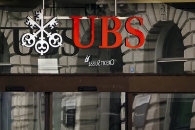 The logos of the Swiss banks Credit Suisse and UBS are displayed at Paradeplatz in Zurich, Switzerland, Sunday March 19, 2023. AP