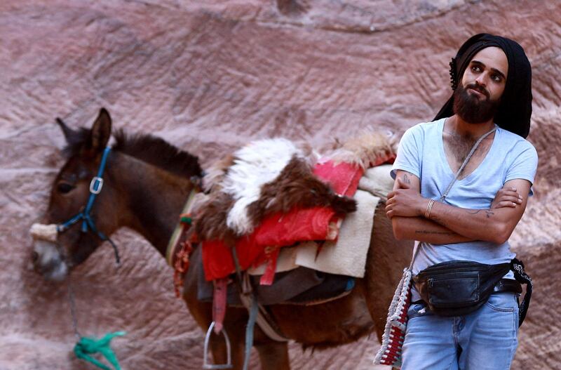 A donkey owner waits for costumers in Petra, where visitor numbers crashed during the Covid-19 pandemic. AFP