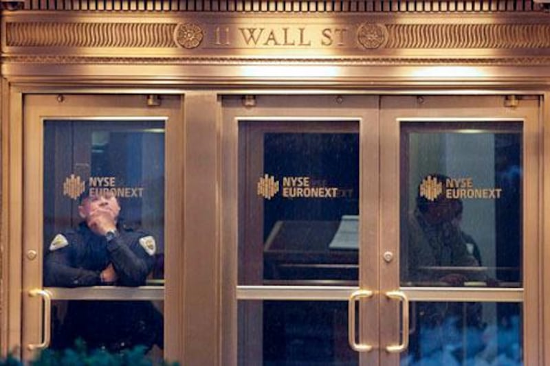 A security guard is seen at the New York Stock Exchange in downtown Manhattan as Hurricane Sandy makes its approach in New York October 29, 2012. Hurricane Sandy, the monster storm bearing down on the U.S. East Coast, strengthened on Monday after hundreds of thousands moved to higher ground, public transport shut down and the U.S. stock market suffered its first weather-related closure in 27 years. REUTERS/Andrew Kelly (UNITED STATES - Tags: ENVIRONMENT BUSINESS) *** Local Caption ***  NYK302_STORM-SANDY-_1029_11.JPG