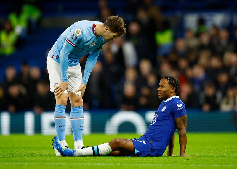 Chelsea's Raheem Sterling goes down injured as Manchester City's John Stones looks on. Reuters