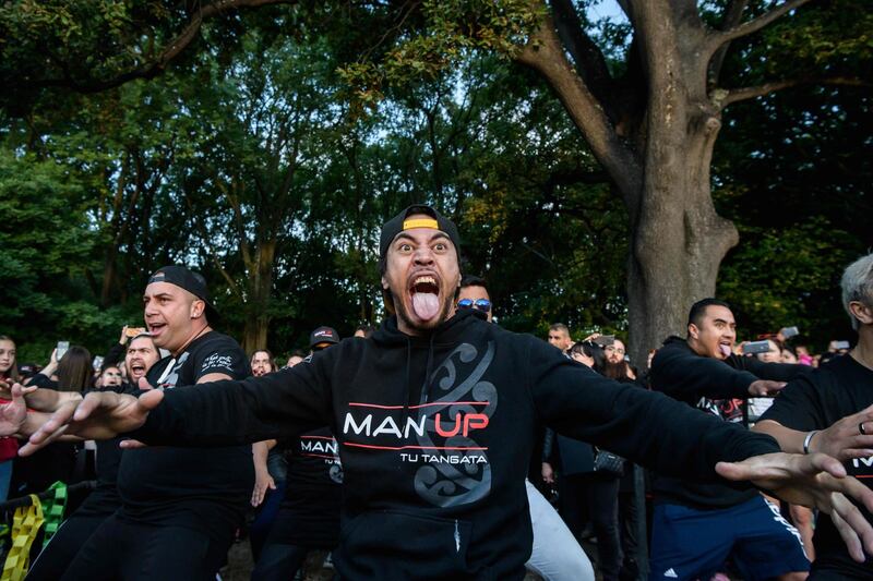 Members of biker gangs perform the haka in front of a gathering of people as a tribute to victims of the shootings  in Christchurch. AFP
