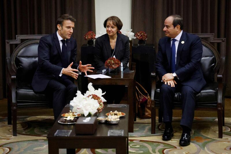 Mr Macron with Mr El Sisi on the sidelines of the conference. AFP