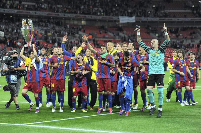 LONDON, ENGLAND - MAY 28:  Pedro of FC Barcelona (L) lifts the trophy as Barcelona celebrate in front of their fans after victory in the UEFA Champions League final between FC Barcelona and Manchester United FC at Wembley Stadium on May 28, 2011 in London, England.  (Photo by Jasper Juinen/Getty Images)