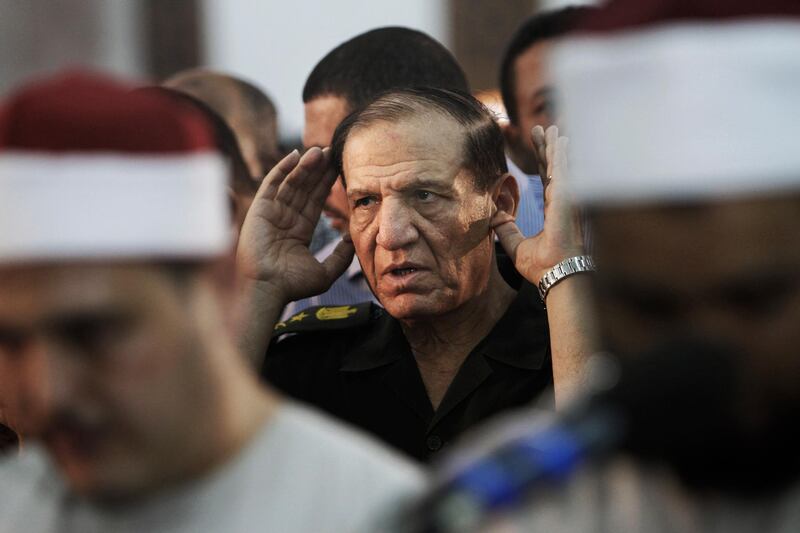 FILE - In this Aug. 5, 2012 file photo, then Egyptian armed forces Chief of Staff, Sami Annan prays for 16 Egyptian soldiers who were killed, in Cairo, Egypt.  The Egyptian military on Sunday, Dec. 22, 2019 released Sami Annan, one of the country's former chiefs-of-staff, nearly two years after his arrest following an announcement that he would challenge President Abdel-Fattah el-Sissi in the 2018 presidential vote, military officials and his lawyer said. (AP Photo/Amr Nabil, File)
