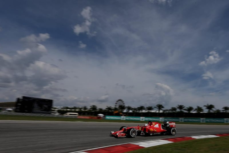 Vettel steers his car on the way to winning the Malaysian Grand Prix at Sepang International Circuit. Andy Wong / AP Photo