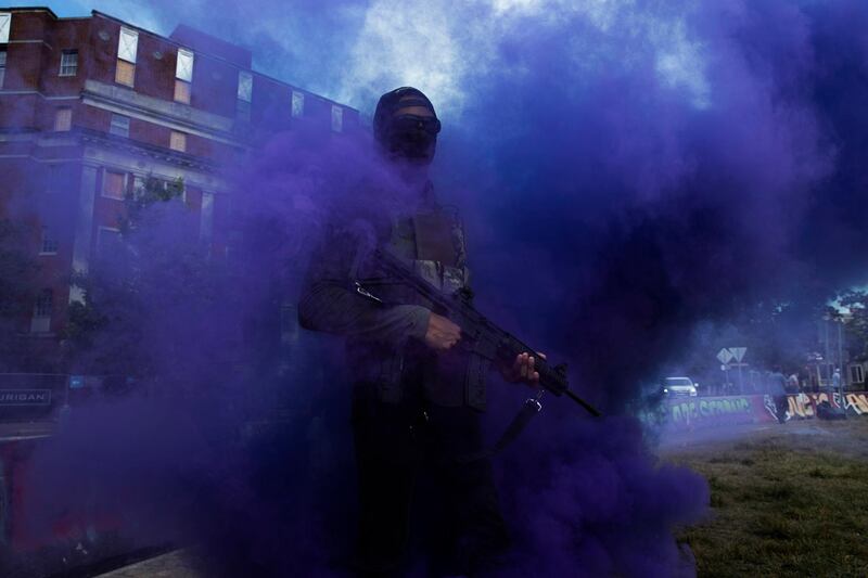 Flare smoke envelopes a supporter of Black Lives Matter carrying a semi-automatic firearm at the base of the statue of Confederate general Robert E Lee in Richmond, Virginia, US. EPA