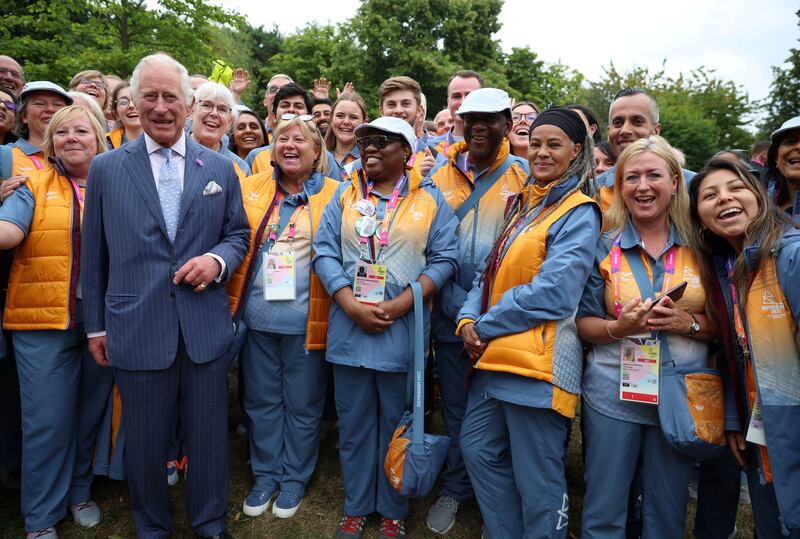 Prince Charles poses with Commonwealth Games volunteers during a visit to the Athletes' Village at the University of Birmingham. AP