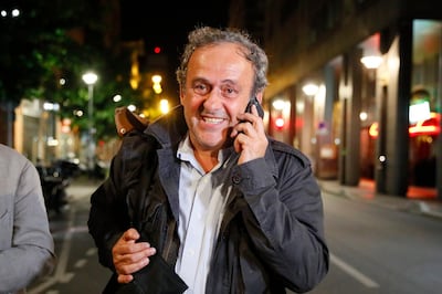 Michel Platini makes a phone call after being freed, outside the French police anti-corruption and financial crimes office in Nanterre, outside Paris, early Wednesday, June 19, 2019. Former UEFA president Michel Platini proclaimed his innocence during police questioning Tuesday following his arrest as part of a corruption probe into the vote that gave the 2022 World Cup to Qatar. (AP Photo/ Francois Mori)