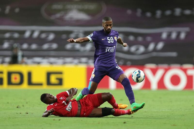 Al Ain's Mohammed Fayez dribbles the ball around Al Ahli's Ismail Salem. Christopher Pike / The National