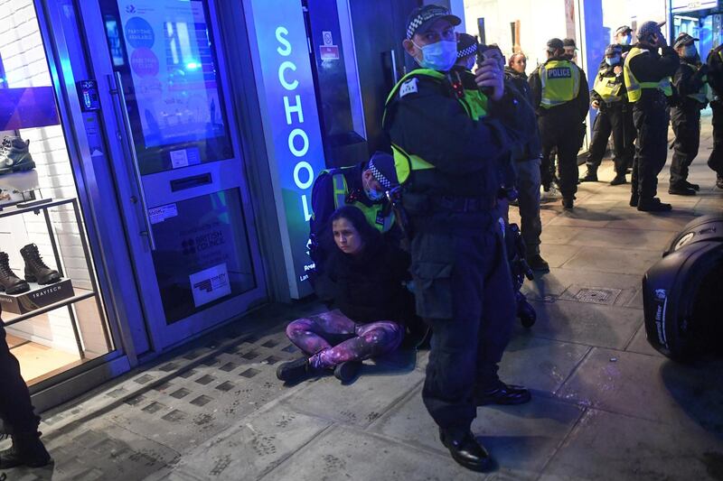 A woman is arrested by Police during a demo on Oxford Street on November 5, 2020 in London, England. Getty Image