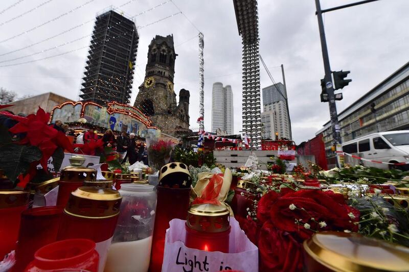 A makeshift memorial for the victims of the Christmas market attack in Berlin on December 24, 2016. A 20-year-old  Syrian asylum-seeker went on trial on January 4, 2017, accused of reconnoitering potential sites in Berlin for ISIL attacks. John MacDougall / AFP 

