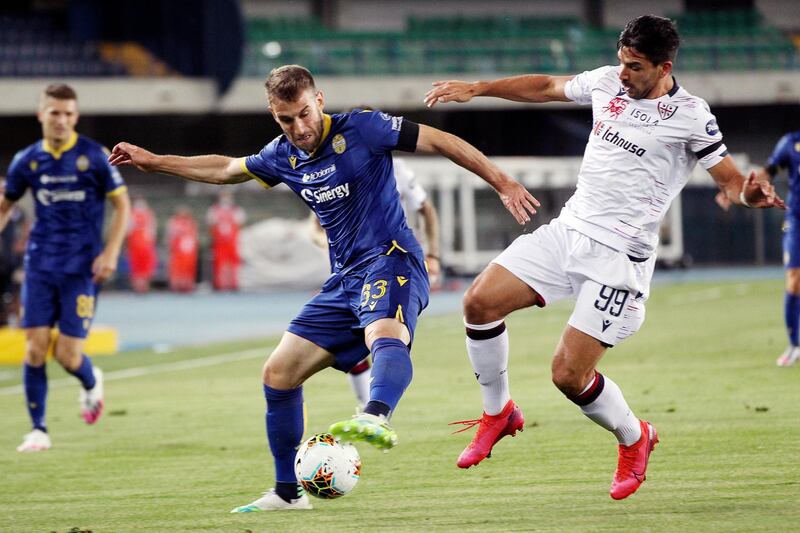 Verona's Alan Empereur (33) battles Cagliari's Giovanni Simeone (99). AP Photo