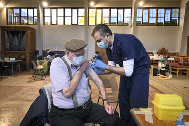 Dr Chris Parry administers the Oxford/AstraZeneca Covid-19 shot at a vaccination centre in Sheffield, UK. AFP