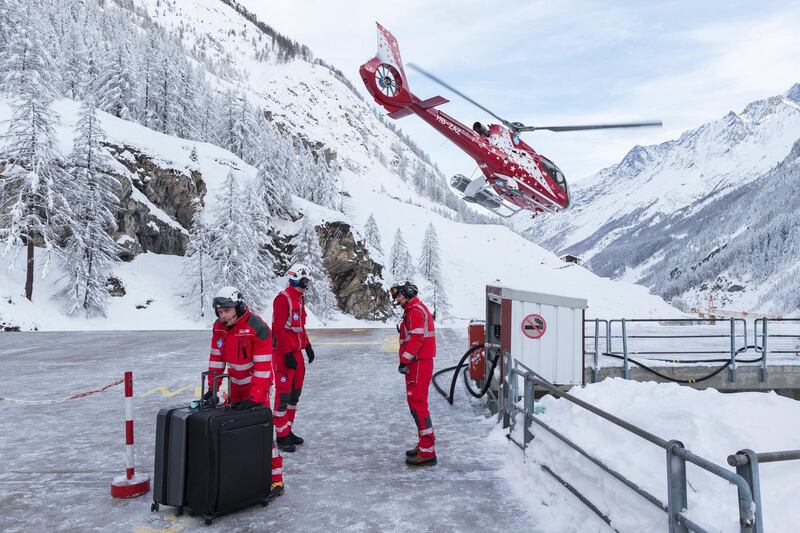 Tourists and their baggage in a helicopter at the heliport of Air Zermatt as airlift evacuation flights are underway into the valley of Raron, in Zermatt, Switzerland. Dominic Steinmann / EPA