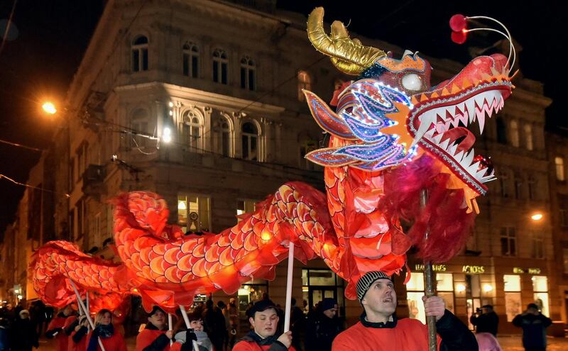 People perform with dragon as they celebrate the Chinese Lunar New Year in  Lviv, Ukraine.  Mykola Tys / EPA