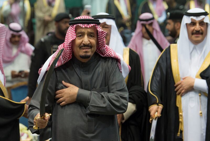 Saudi Arabia's King Salman bin Abdulaziz Al Saud performs the traditional Ardha sword dance as part of the activities of Janadriyah Culture festival, in Riyadh, Saudi Arabia February 20, 2018. Bandar Algaloud/Courtesy of Saudi Royal Court/Handout via REUTERS ATTENTION EDITORS - THIS PICTURE WAS PROVIDED BY A THIRD PARTY.