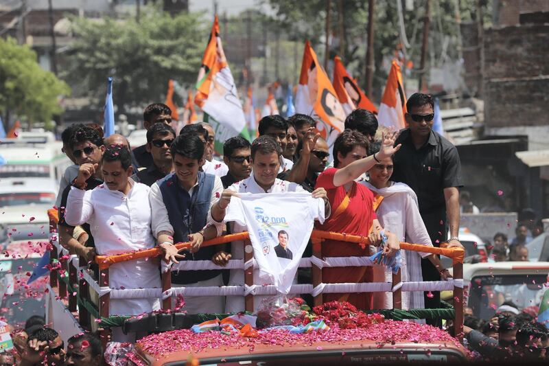Indian National Congress party president Rahul Gandhi (L) and his sister Priyanka Gandhi (R) wave during a roadshow before filing his nomination for the upcoming general election at the district collector's office in Amethi on April 10, 2019.
PHOTO : JITENDRA PRAKASH