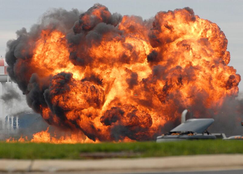 A single engine T-28 from the six-plane Trojan Horsemen Demonstration Flight Team crashes and explodes during a performance at the Thunder Over the Blue Ridge Open House and Air Show, Saturday, Sept. 17, 2011 at the 167th Airlift Wing in Martinsburg, W.Va. (AP Photo/Journal Newspaper, Ron Agnir) *** Local Caption ***  Crash WV Air Show.JPEG-0fbb8.jpg
