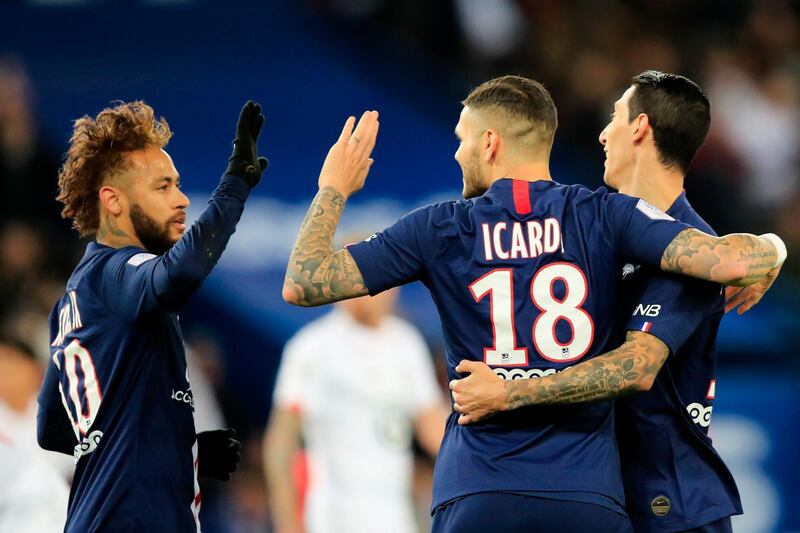 PSG's Mauro Icardi, centre, celebrates with teammates Neymar and Angel Di Maria after scoring the opening goal against Lille. AP