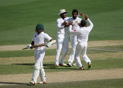 DUBAI, UNITED ARAB EMIRATES - OCTOBER 08:  Dilruwan Perera of Sri Lanka celebrate with teammates after dismissing Sami Aslam of Pakistan during Day Three of the Second Test between Pakistan and Sri Lanka at Dubai International Cricket Ground on October 8, 2017 in Dubai, United Arab Emirates.  (Photo by Francois Nel/Getty Images)