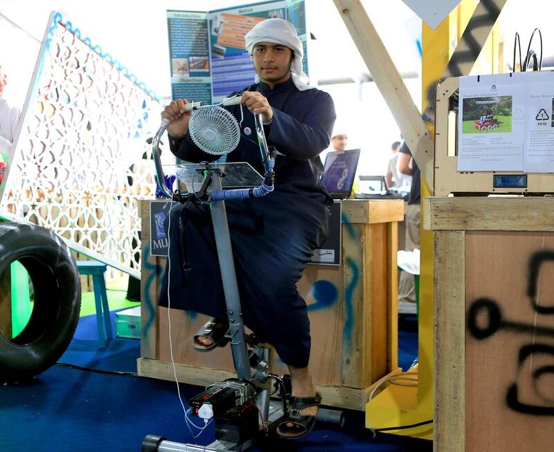 Mohamed Al Dhanhani demonstrates his multi-purpose exercise machine project to visitors on the opening day of Innovator show on Thursday on Corniche beach in Abu Dhabi. Ravindranath K / The National